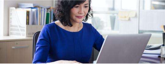 A woman in front of her laptop