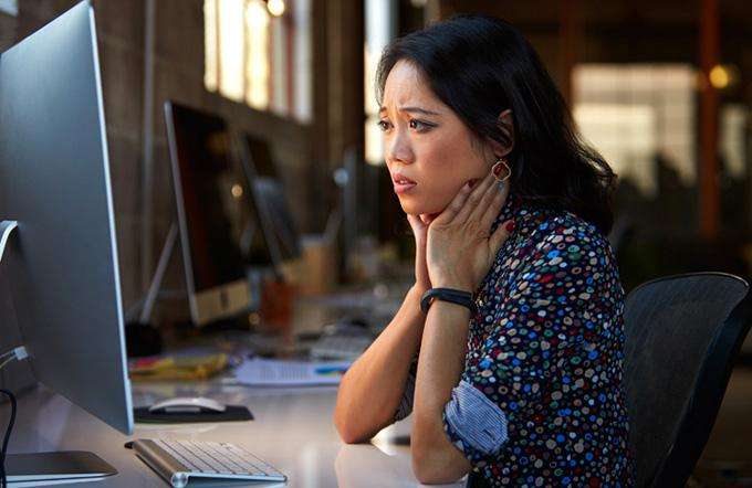 Business Email Compromise is on the rise Woman looking at a computer